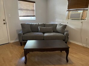 Cozy living room with window-type AC.