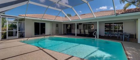The outdoor entertaining area features a covered lanai & screened 15' x 26' pool