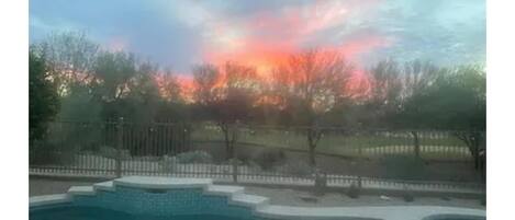 Beautiful morning sunset looking out over   pool/spa & golf course!