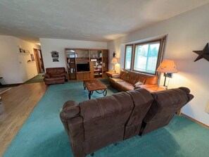 Spacious living room with comfy couches and TV