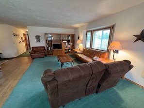 Spacious living room with comfy couches and TV