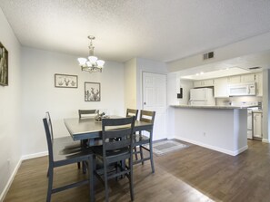 Clean and modern large dining area with  table that seats 6.