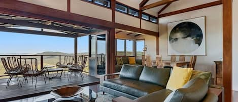 Main lounge with bi-fold doors to the deck lounging area, combining indoor and outdoor living perfectly.