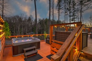 New 5 person hot tub off back deck with plenty of lighting and a privacy wall. 