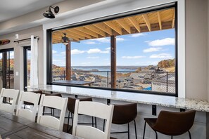 Huge picture window with bar overlooking lake