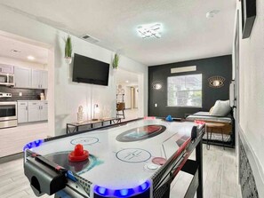 Game table, extra bed with two twin mattresses, and TV