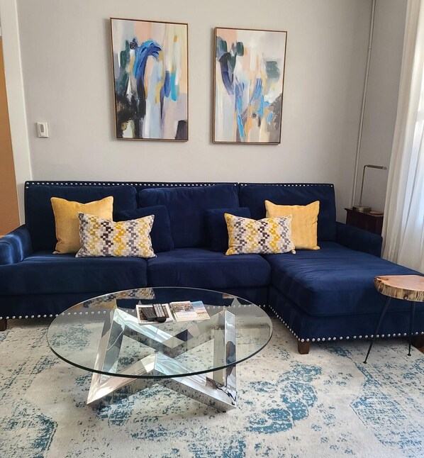 The daylight-filled living room is cozy & colorful!