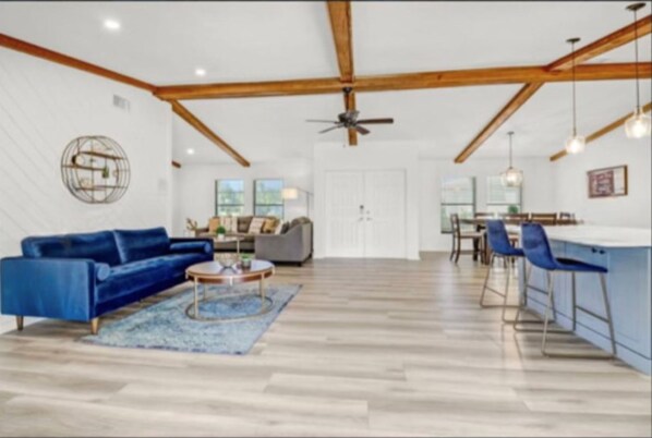Vaulted ceilings with wood beams, luxury vinyl floors and modern decor.