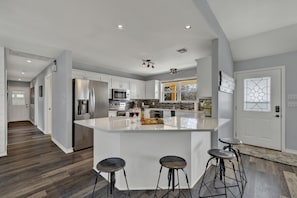 Full kitchen with bar seating for four.