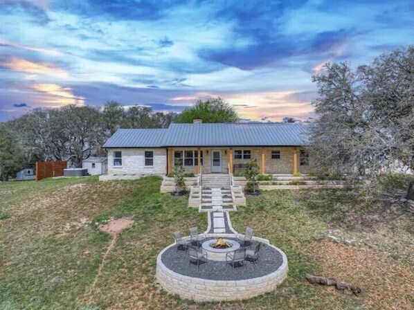 Gather around the firepit in the spacious backyard.