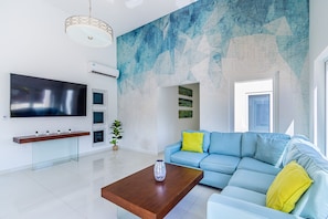 Living room with high ceilings and sleek wide tiling