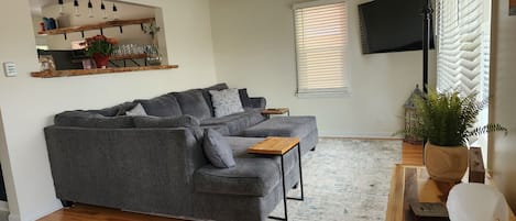 Living Room With Sectional and TV, plenty of light in this home!