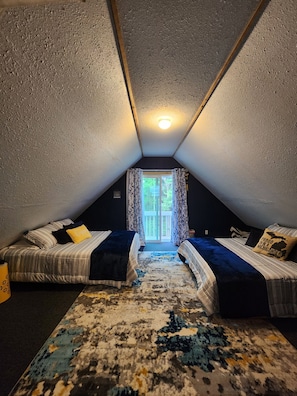 Bedroom #3 on the upper level with 2 Queen beds & a blow-up child's mattress.