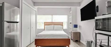 Queen sized bed with premium mattress and bed linens.