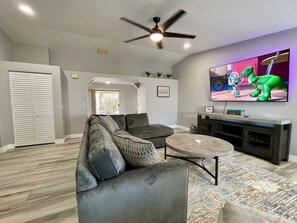 Spacious and comfortable living room with 82" 4K smart tv.