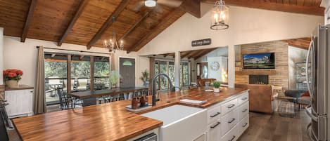 Beautifully updated butcher block island with farmhouse sink.