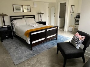 Cozy Queen size bed with additional seating.