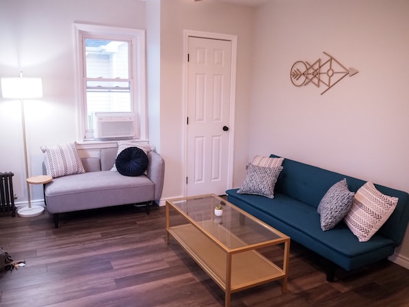 As you enter, you are welcomed by a comfy living room.