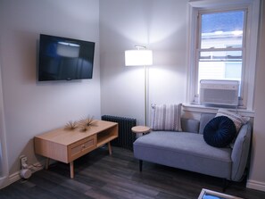 The window AC unit will keep you cool in the summer and our TV has several streaming services available.