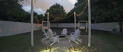 Beautiful custom-made paver walkway with fire pit.  Handmade Adirondack chairs. 