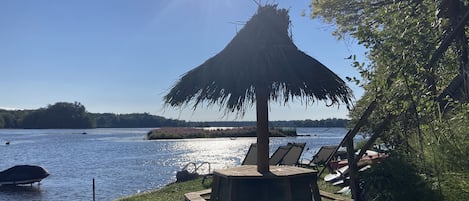 Private beach area complete with  beach loungers, SUP's, kayaks, paddle boat