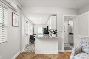 Kitchen counter-top, and table for two for dining. 