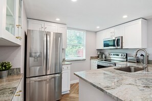 Full kitchen with a refrigerator that has filtered water.