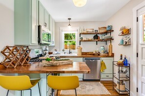 Fully stocked kitchen with gas stove.