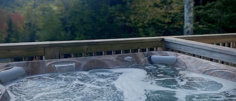 Relax in your hot tub while overlooking the forest and mountains