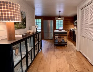 Kitchen area with washer, dryer and pantry in the closet to the right.