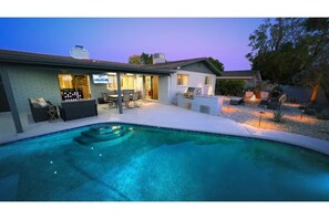 The relaxing iridescent pool light compliments the fire and the path lights