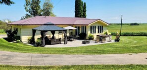 Seasonal patio with gazebo, dining, gas grill, firepit and hot tub.