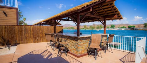 Cabana with BBQ and six chairs overlooking river