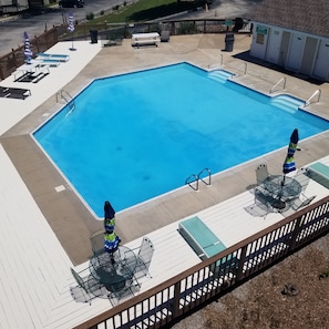 Arial view of the resort's large outdoor pool, hot tub, and seating areas!