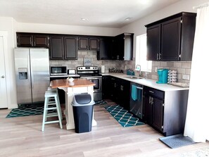 Fully stocked kitchen with all the things needed to prepare a full meal.