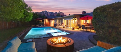 Back yard with firepit, heated pool, and hot tub!