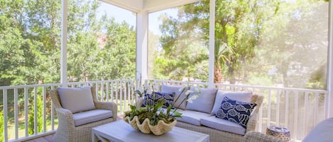 Whispering Palms features this wonderful screened porch.