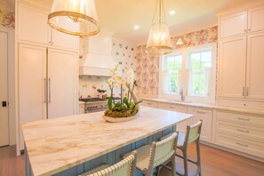 This kitchen features top-of-the-line appliances, custom cabinetry and designer fixtures.