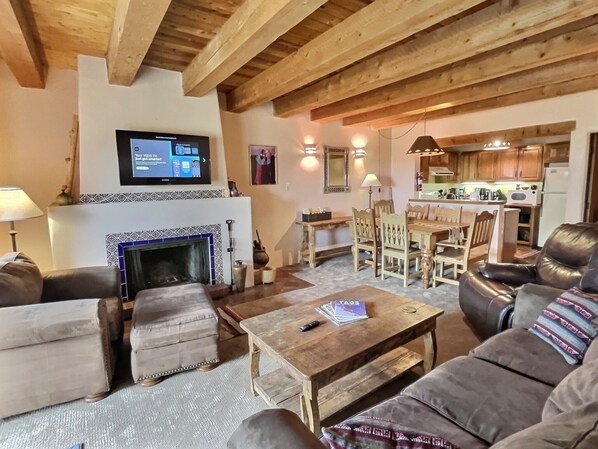 Living Area with overstuffed leather furniture, fireplace, and smart TV