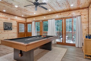 Game room features a pool table.