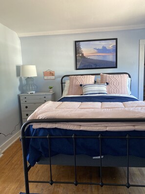 Upstairs bedroom 1 has a sunset theme with queen bed,  vanity and closet. 