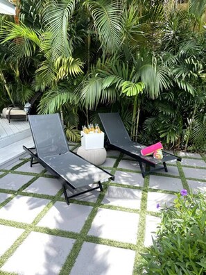 Two loungers poolside, beach towels provided