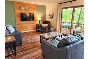 Updated living room with comfortable leather furniture and a reading chair