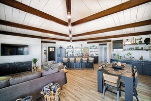 Exposed Beams extend across the ceiling of the open concept living/dining area. 