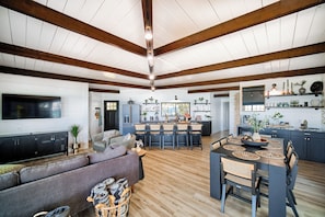 Exposed Beams extend across the ceiling of the open concept living/dining area. 