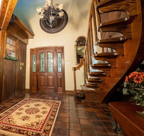 The foyer entrance floating staircase and customized exterior rooftop inside.