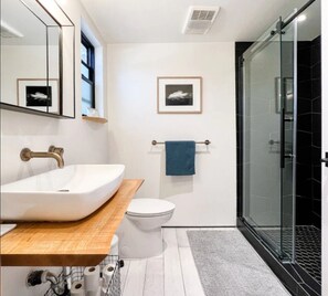 Renovated bathroom off the bedroom with large walk-in shower