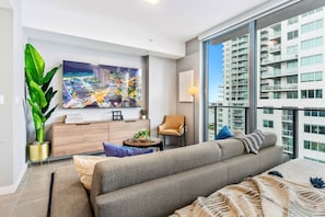 Living/sleeping area w/ king bed, 65" Smart TV - Capturing the amazing views of the city from your own spot at this charming studio apartment.