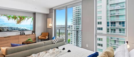 Living/sleeping area w/ king bed, 65" Smart TV - Capturing the amazing views of the city from your own spot at this charming studio apartment.