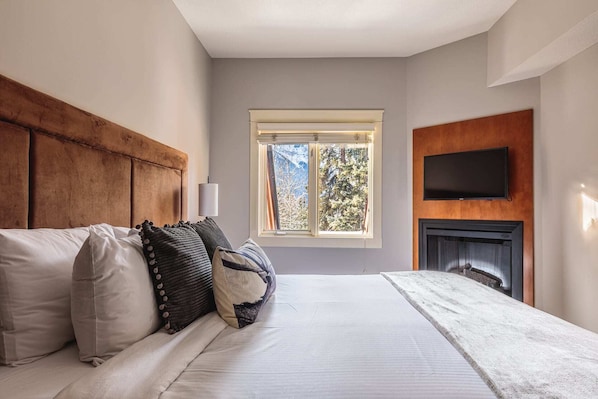 Comfy king bed with electric fireplace - perfect for cozy winter nights